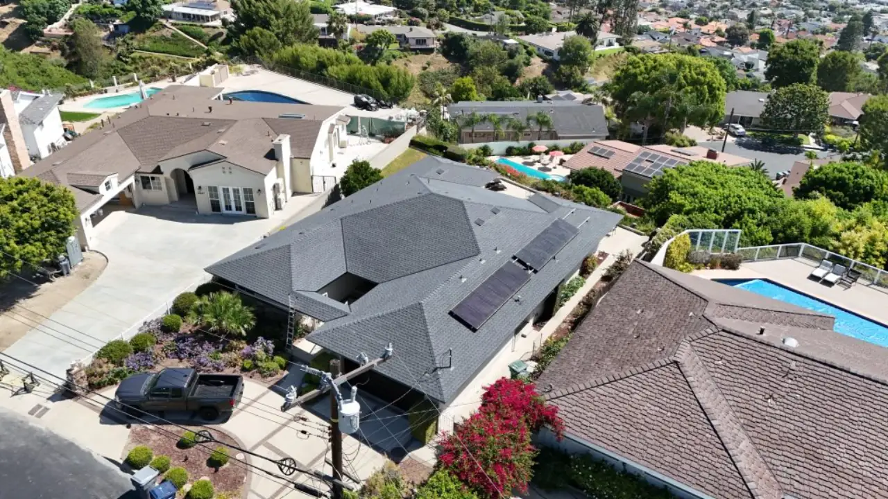 Gray pitched roof surrounded by neighboring homes